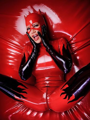 Sexy Flirtatious Cat Woman Bianca Beauchamp Poses In Red And Black Latex Suit